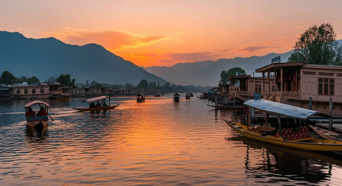 Shikara ride at Dal Lake Srinagar during sunset, featuring houseboats and mountains, romantic Srinagar tour package.