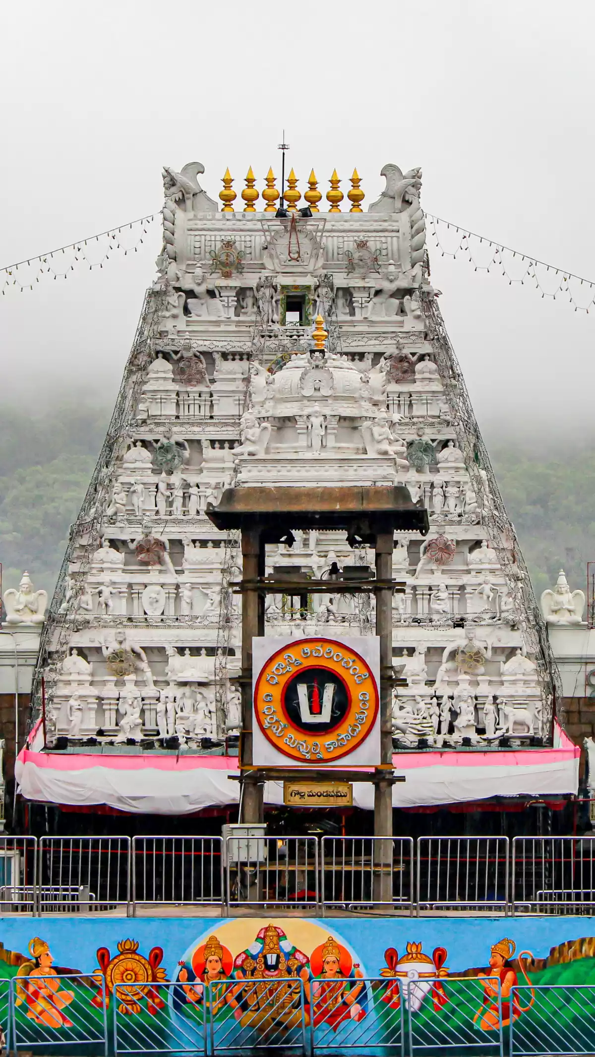 Sri Venkateswara Temple gopuram at Tirupati, Andhra Pradesh, featuring intricate white carvings and sacred symbols, a revered pilgrimage destination included in Andhra Pradesh tour packages.