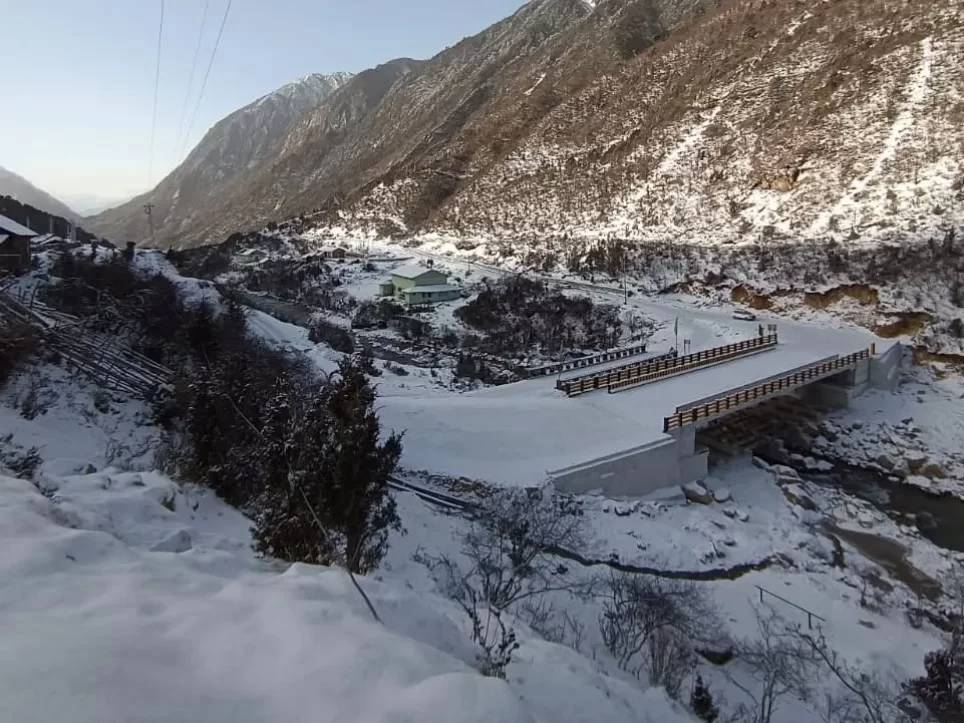 Thangu Valley North Sikkim snow covered Himalayan valley with river bridge and scenic mountain landscape