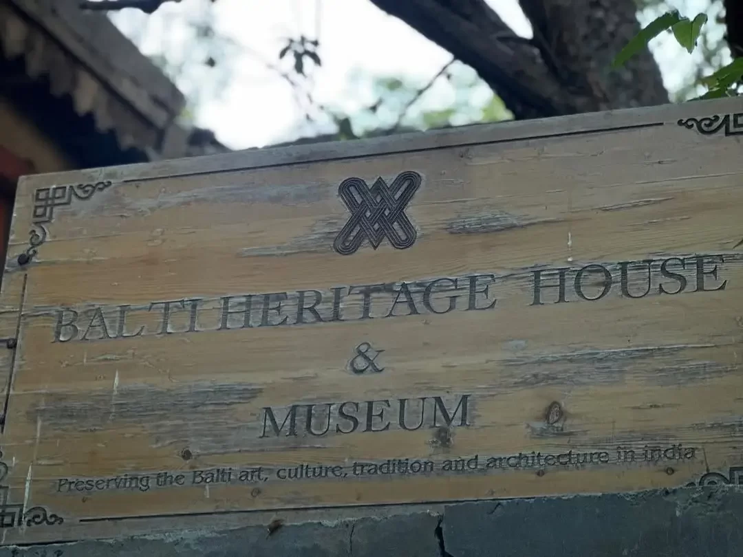 Balti Heritage House and Museum signboard in Turtuk village Nubra Valley Ladakh during daylight, featuring traditional art culture architecture logo, perfect cultural Turtuk tour package.
