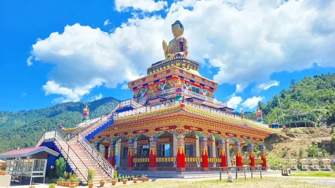 Buddha Heritage Park in Ravangla during daylight, featuring giant Buddha statue and Himalayan hills, perfect spiritual experience, Sikkim tour packages.
