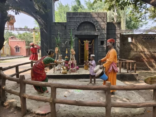 Sai Baba temple gate toran mangalcharan puja ceremony statue at Sai Heritage Village near Naini Lake Nainital, with banana plants, kalash, boy drummer, saffron-robed priest, bride, groom in red turban, perfect cultural heritage experience Uttarakhand tour