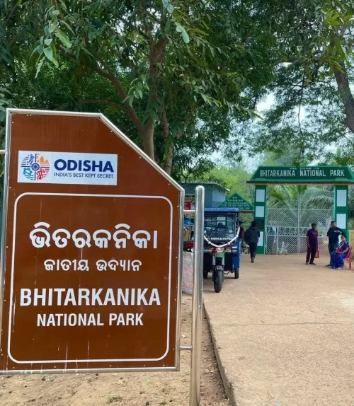 Entrance sign of Bhitarkanika National Park in Odisha with gateway and visitors highlighting wildlife tourism in Odisha tour packages