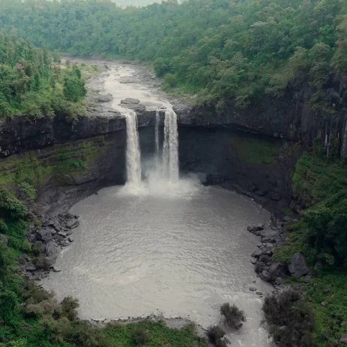 Gira Waterfall Surat Gujarat during monsoon, featuring twin cascades and lush forest cliffs, perfect nature escape Gujarat tour package