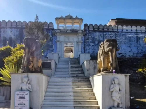 Achalgarh Temple entrance with stone elephant statues and marble steps, a historic religious site in Mount Abu, Rajasthan.