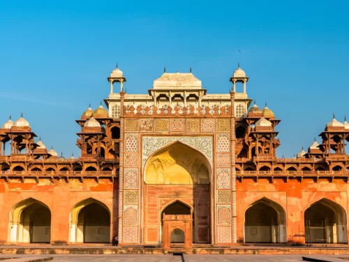 Akbar's Tomb Agra Uttar Pradesh grand entrance red sandstone inlays white marble minarets domes intricate jali work blue sky Mughal architecture UNESCO heritage site, perfect Golden Triangle heritage tour package.