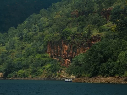 Akkamahadevi Caves scenic riverside limestone caves surrounded by lush hills in Andhra Pradesh tour packages.