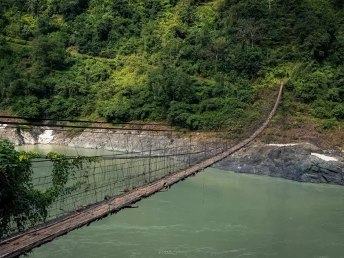 Along Hanging Bridge over Siang River in Aalo, Arunachal Pradesh surrounded by lush green hills