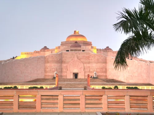 Ambedkar Stupa at memorial park Lucknow during sunset, featuring golden dome pillars palms reflections, perfect cultural Uttar Pradesh tour package.