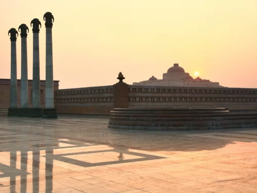Ambedkar Memorial Park at Lucknow during sunset, featuring pillars amphitheater dome reflections, perfect cultural Uttar Pradesh tour package.