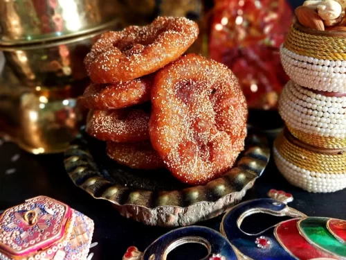 Anarsa, crispy deep-fried Maharashtrian sweet made from rice flour and jaggery, coated with poppy seeds, traditional Indian festive delicacy.
