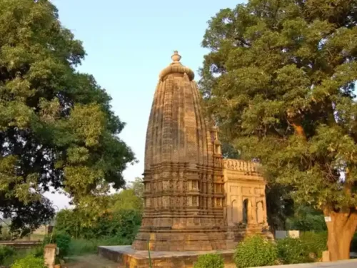 Asri Adinath Digambar Jain Mandir in Madhya Pradesh with intricately carved stone shikhara surrounded by lush trees, a serene heritage temple often featured in Madhya Pradesh tour packages.