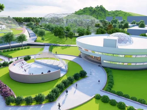 Modern geodesic domes at Assam State Zoo cum Botanical Garden Guwahati during sunny day, featuring green lawns walkways buildings hills, perfect family experience Assam tour package.