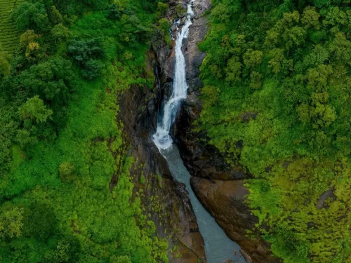 Attukad Waterfalls, Munnar Kerala cascading waterfall amid lush green hills and rocky cliffs in Western Ghats.