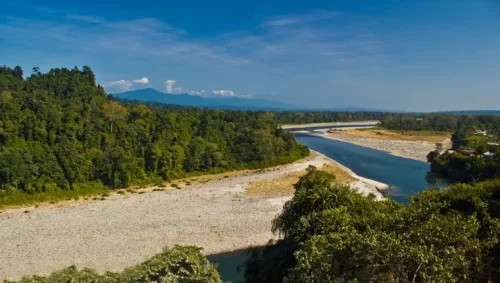 Sesa view point near Bhalukpong featuring scenic river bend, dense green forests, and distant mountains, perfect Arunachal Pradesh tour package experience.
