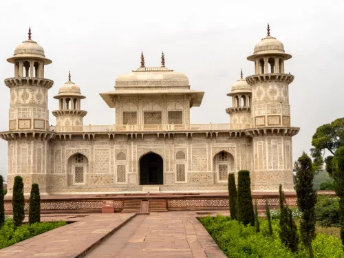 Baby Taj Mahal (Itimad-ud-Daulah Tomb) in Agra during misty weather, featuring marble minarets, gardens, trees, perfect heritage experience Agra tour package.