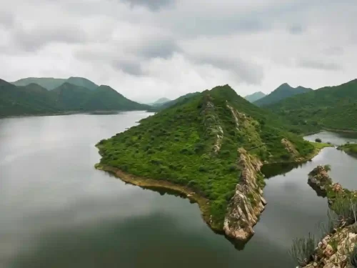 Badi Lake aerial view of the lush green hills surrounding the freshwater lake, a scenic nature spot in Udaipur.