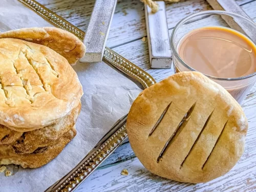 Bakarkhani in flaky baked flatbread texture with light butter glaze, authentic Indian traditional bread, warm and fresh Indian cuisine delight.