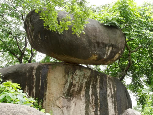 Balancing Rock Jabalpur Madhya Pradesh near Madan Mahal Fort, precarious boulder geological wonder survived 1997 earthquake volcanic erosion formation, ideal Madhya Pradesh tour package.