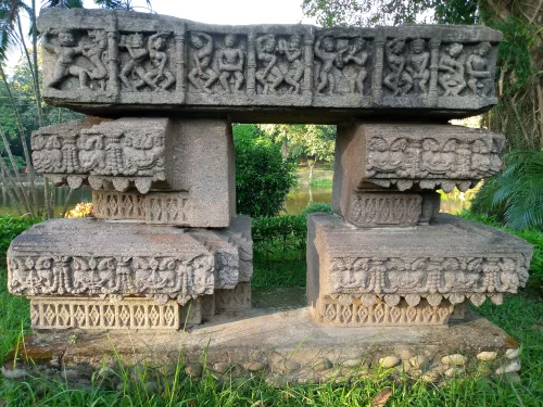 Bamuni Hills Tezpur ancient intricately carved stone doorframe sculptures figures palms bushes pond greenery Chitralekha Udyan park, perfect 10th century archaeological gem Assam tour packages.