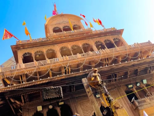 Banke Bihari Temple Vrindavan ornate facade with arches and flags, famous Krishna temple in Uttar Pradesh
