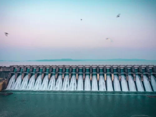 Bargi Dam and Reservoir in Jabalpur with multiple spillway gates releasing water at sunset, a scenic highlight often included in Madhya Pradesh tour packages