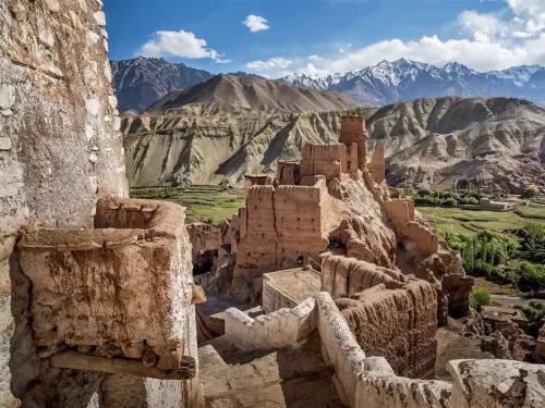 Ancient Basgo Fort ruins at Basgo Monastery Leh Ladakh during clear sky day, featuring multi-tiered earthen walls Indus Valley snowy Zanskar mountains, perfect heritage adventure experience with Basgo Fort Leh tour package.