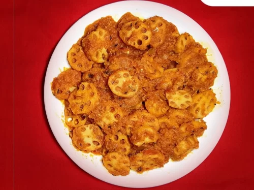 Bhey in spicy lotus stem curry with aromatic masala and cilantro garnish, authentic Indian vegetable dish, steaming hot Indian cuisine delight