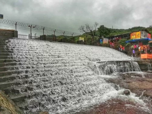 Bhushi Dam Lonavala. Popular monsoon picnic spot with cascading water steps and scenic hill views.