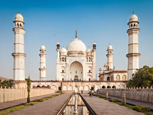 Bibi Ka Maqbara Aurangabad symmetric view white minarets domes central pathway fountain greenery tourists blue skies, perfect Maharashtra heritage tour package.