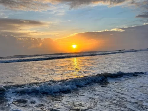 Cavelossim Beach Goa serene sunset view with golden sky and Arabian Sea waves along sandy shoreline