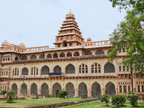 Raja Mahal palace at Chandragiri Fort Tirupati during clear skies, featuring terracotta gopuram and arches, perfect cultural experience Andhra Pradesh tour packages.