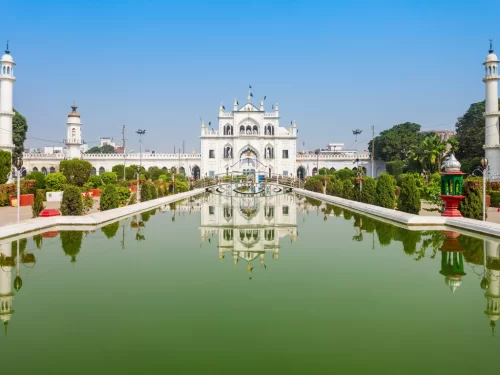 Chota Imambara reflection in pool at Lucknow during blue sky day, featuring domes minarets gardens fountain, perfect cultural Uttar Pradesh tour package.
