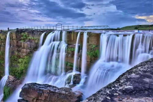 Dainthlen Falls in Meghalaya, dramatic waterfall plunging over rocky cliffs into a deep gorge.