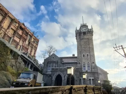 Darjeeling Clock Tower in Darjeeling, West Bengal, historic stone building with tall clock structure and hillside surroundings, popular landmark featured in West Bengal tour packages
