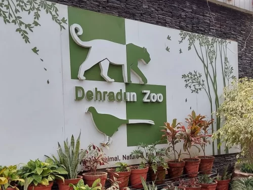 Entrance signage of Dehradun Zoo in Dehradun, Uttarakhand surrounded by greenery, a family-friendly attraction featured in Uttarakhand tour packages