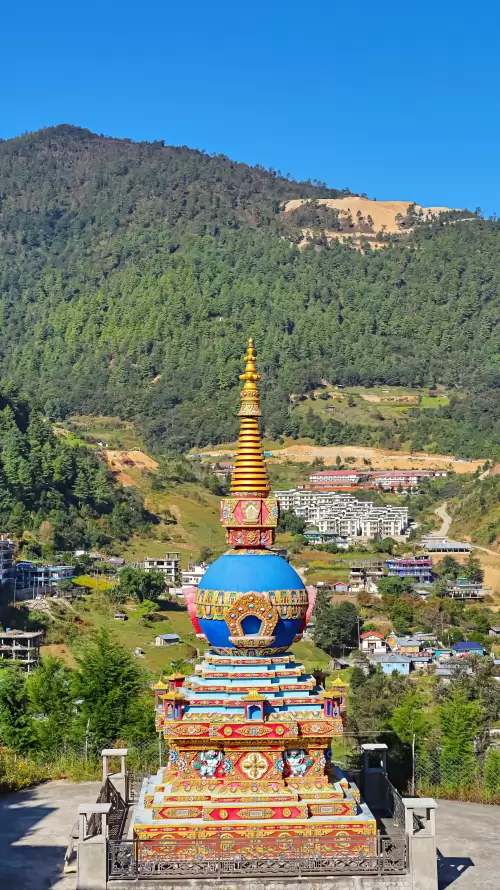 Colorful Buddhist stupa in Dirang Arunachal Pradesh with scenic mountain backdrop showcasing cultural heritage in Arunachal Pradesh tour packages