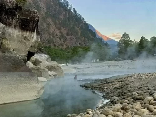 Dong Krong Hot Spring natural geothermal hot water spring surrounded by scenic mountains and rocky landscape in Arunachal Pradesh Package.
