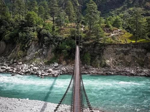 Dong Village scenic riverside hamlet with suspension bridge and lush mountain surroundings in Arunachal Pradesh Package.