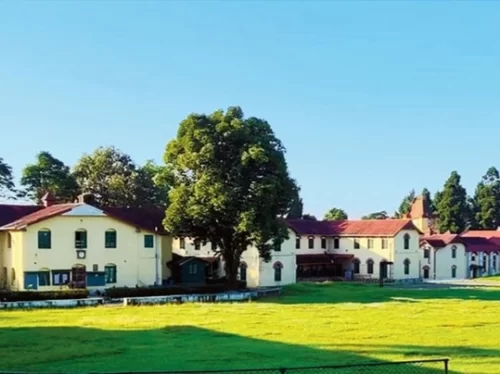 Dr. Graham’s Homes School campus in Kalimpong, West Bengal, featuring colonial-era buildings with red roofs set amid open green grounds, a historic educational landmark often highlighted in West Bengal tour packages.