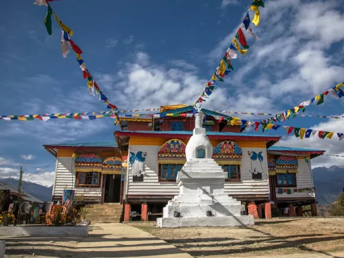 Dzogchen Samtan Choeling Monastery in Arunachal Pradesh with colorful prayer flags and Buddhist stupa