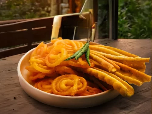 Fafda Jalebi in crispy gram flour fafda with saffron sugar syrup jalebi, authentic Indian Gujarati snack, hot Indian cuisine delight.