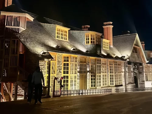 Gaiety Heritage Cultural Complex Shimla historic Gothic theatre illuminated at night with golden lights people stone facade, perfect cultural evening experience, Himachal Pradesh tour packages.