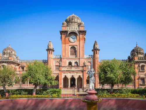 Mahatma Gandhi Hall (Ghanta Ghar) at Indore Madhya Pradesh in clear daylight, featuring red sandstone clock tower domes and statue, perfect cultural Madhya Pradesh tour package.