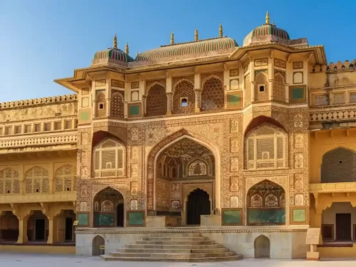 Ganesh Pol ornate gateway at Amber Fort featuring colorful frescoes of Lord Ganesh and intricate latticed windows in Jaipur Rajasthan.