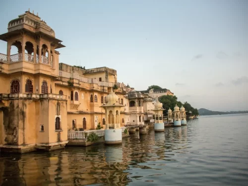 Gangaur Ghat historic stone stairs leading to Lake Pichola with arched gateways and traditional architecture in Udaipur Rajasthan.