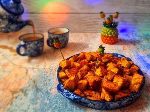 Garadu in spicy roasted yam cubes with chili and lemon garnish, authentic Indian street food snack, hot Indian cuisine delight.