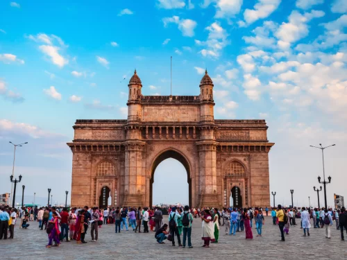 Gateway of India bustling tourist crowd under blue evening sky, showcasing Mumbai’s iconic waterfront monument, heritage architecture, and popular gathering spot for city tours and Elephanta ferry rid