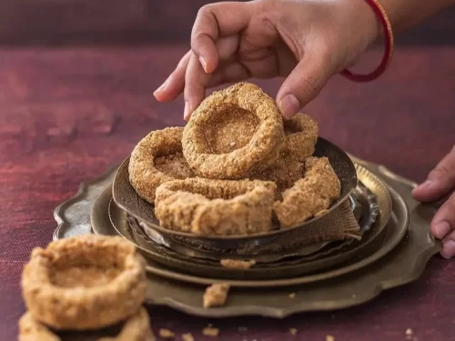 Gaya ki Tilkut in crushed sesame jaggery sweet with rustic texture, authentic Indian traditional dessert, crunchy Indian cuisine delight.