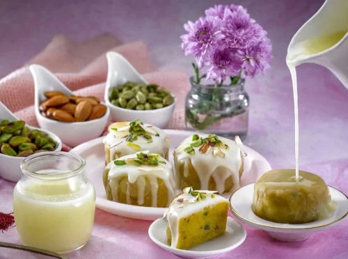 Ghari in rich ghee-filled sweet with creamy milk glaze and pistachio garnish, authentic Indian Surti dessert, indulgent Indian cuisine delight.